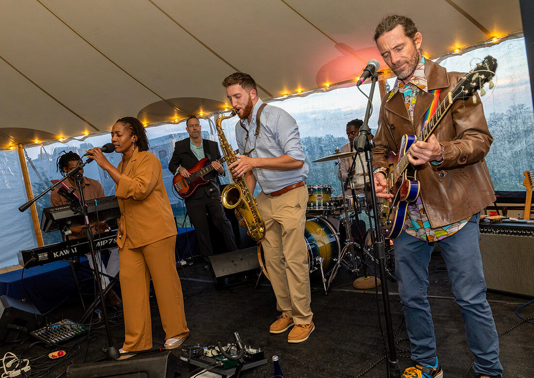 Dawson Bertrand and full band performing at a luxury tented event