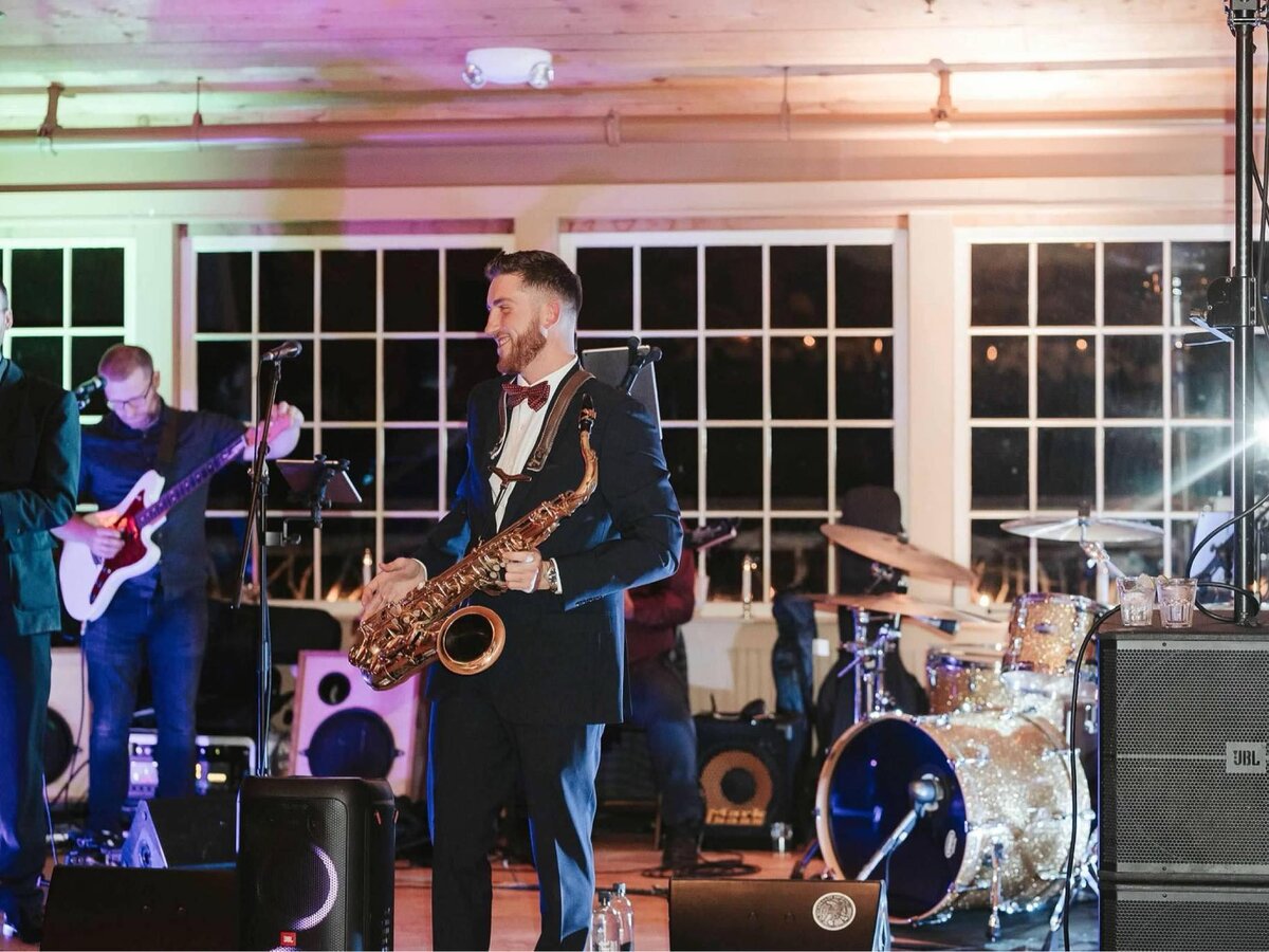 Dawson Bertrand performing live saxophone with his band at a private event